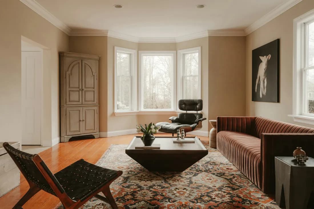 A contemporary, naturally lit living space representing room design.